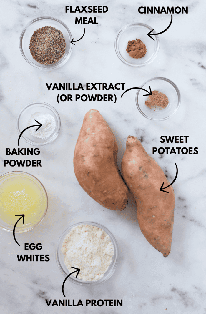 A photo of ingredients for sweet potato protein pancakes laying flat against a white marble surface.