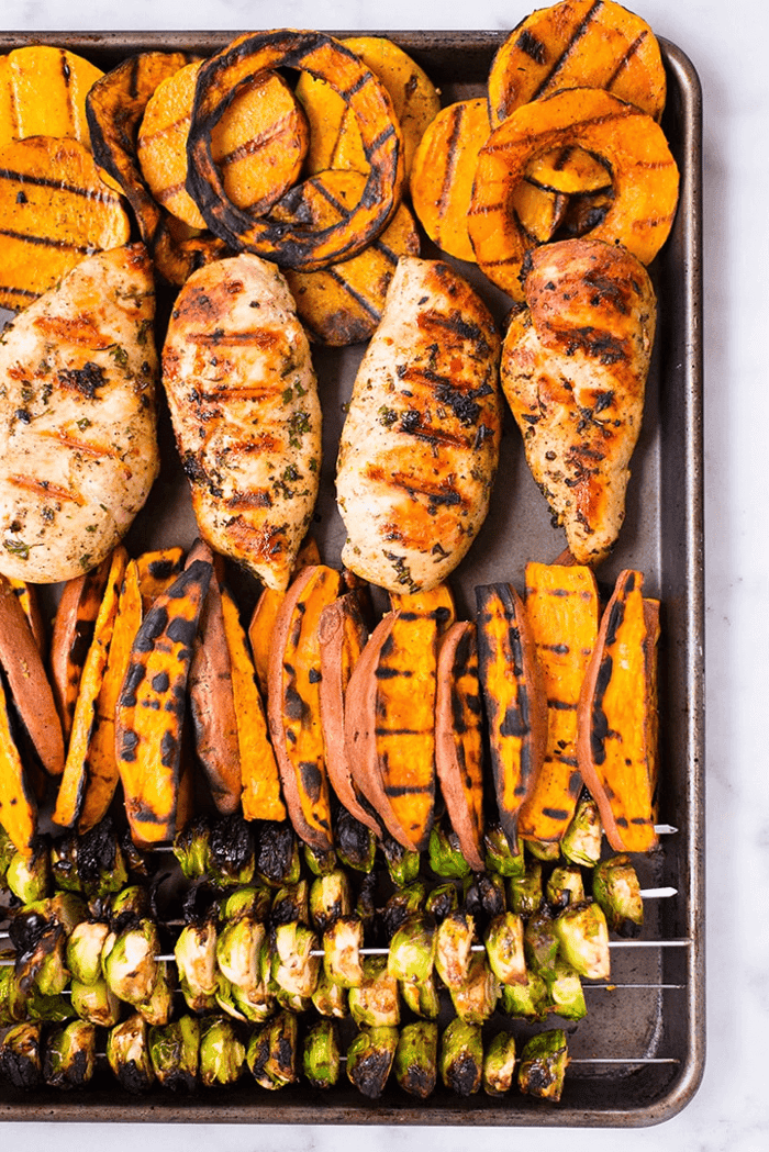 An image of healthy fall grill meal prep all cooked and ready to store on a baking sheet.