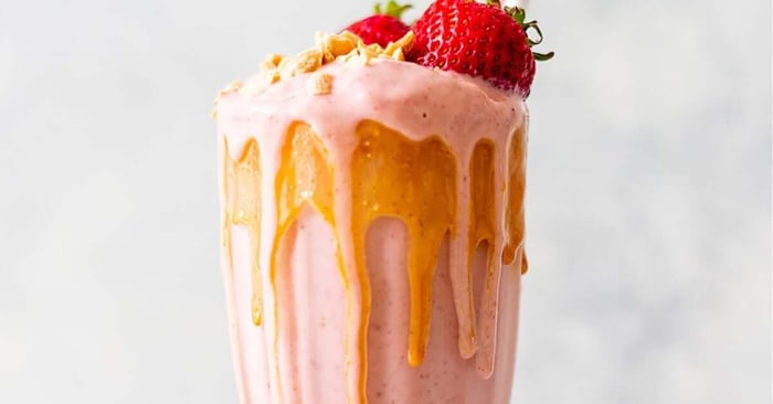 An image of a white background with a finished and plated PB & J Protein Smoothie.