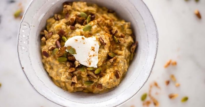 An image of a white bowl with pumpkin pie overnight oats.