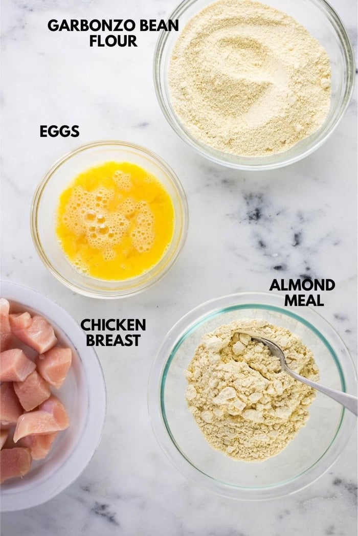 Ingredients for healthy general tso chicken laid out against a white marble surface.