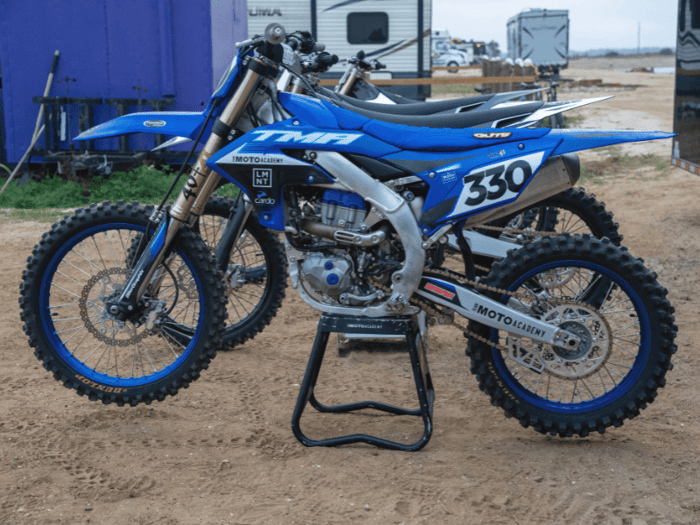 The Moto Academy rental bike fleet — Stark Varg Electric, Kawasaki KX250, Yamaha YZ450, Kawasaki KX450 Race-Ready, and Honda CRF110 available at every 5-Day Camp