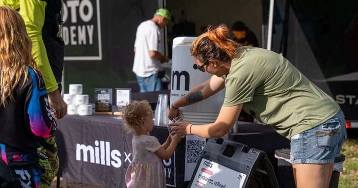 The Mills table at the Moto Academy trailer, with a sample being handed out during a 5-Day Camp.