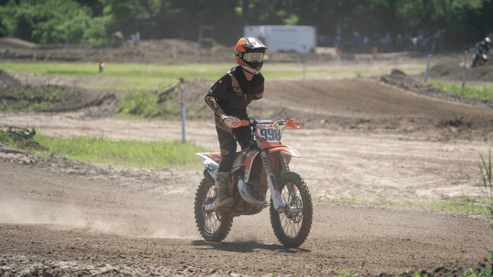 A TMA rider practicing a one-hand grip drill — training the body to maintain control without over-gripping the bars