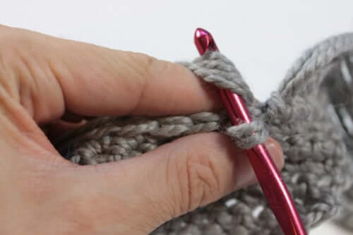 Attaching fringe to a project using a crochet hook. Find more finishing tips on the Woolery blog.