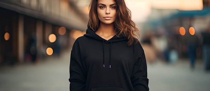 Woman in oversized streetwear hoodie from curated capsule wardrobe in minimalist neutral tones