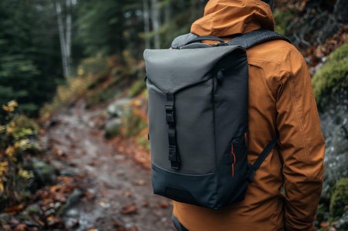 Person wearing a durable outdoor jacket while hiking, representing the performance and reliability of the most durable clothing brands.