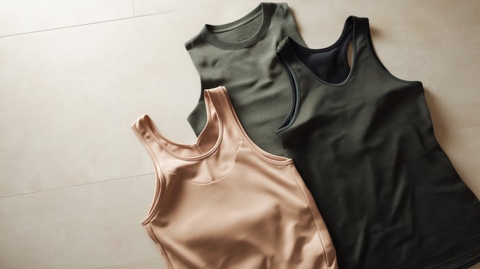 Minimalist soft workout clothes flatlay featuring sustainable activewear essentials in neutral tones