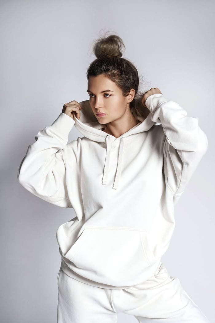 Model wearing a sustainable premium streetwear hoodie in a minimalist design, styled for an eco-conscious look.