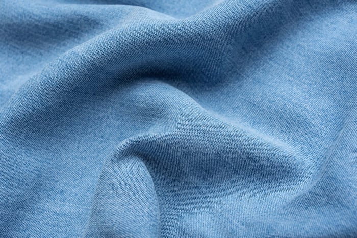 Close-up of soft neutral-toned Tencel fabric showing texture and durability related to whether Tencel Lyocell shrinks
