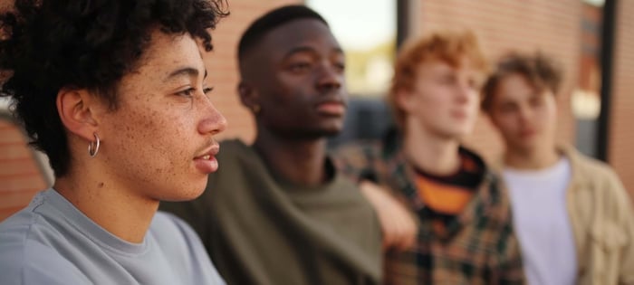 Diverse Gen Z group wearing minimalist streetwear with neutral tones and modern casual style