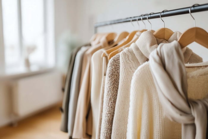 Neutral clothing rack with minimalist wardrobe pieces in a clean minimal closet setup