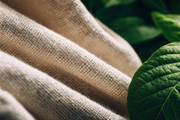 Close-up of sustainable fabrics with soft textures and neutral tones for a minimal closet wardrobe