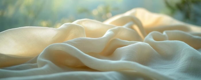 Close-up of sustainable TENCEL™ Lyocell fabric highlighting its soft texture, smooth finish, and eco-friendly material used in modern minimal clothing.