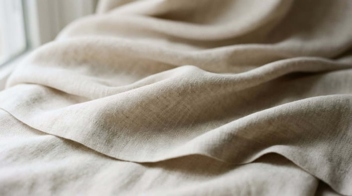 Close-up of natural fabric texture highlighting the soft, durable material commonly used in PFAS-free yoga pants with a minimalist, eco-conscious design.