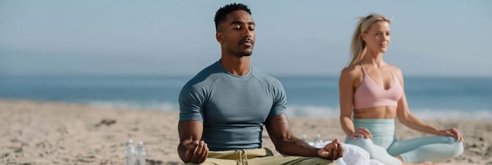 Two yogis practicing together in sustainable yoga clothes during a wellness and mindfulness session.