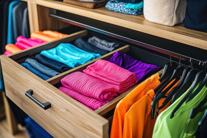 Folded workout sets neatly stacked in a drawer, showcasing organized activewear and minimalist storage