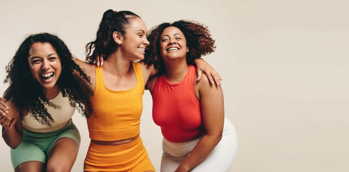 Group of Gen Z women wearing minimalist workout sets in neutral tones, showcasing modern activewear style and comfort