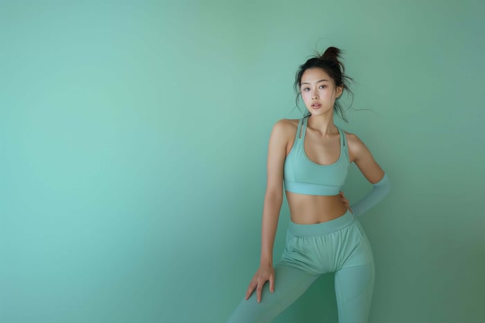 Young woman wearing a minimalist matching workout set in neutral tones, showcasing stylish and comfortable activewear