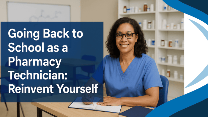 A smiling mid-career pharmacy technician wearing blue scrubs sits at a classroom desk writing in a notebook, with pharmacy shelves and textbooks in the background. Text overlay reads, “Going Back to School as a Pharmacy Technician: Reinvent Yourself.