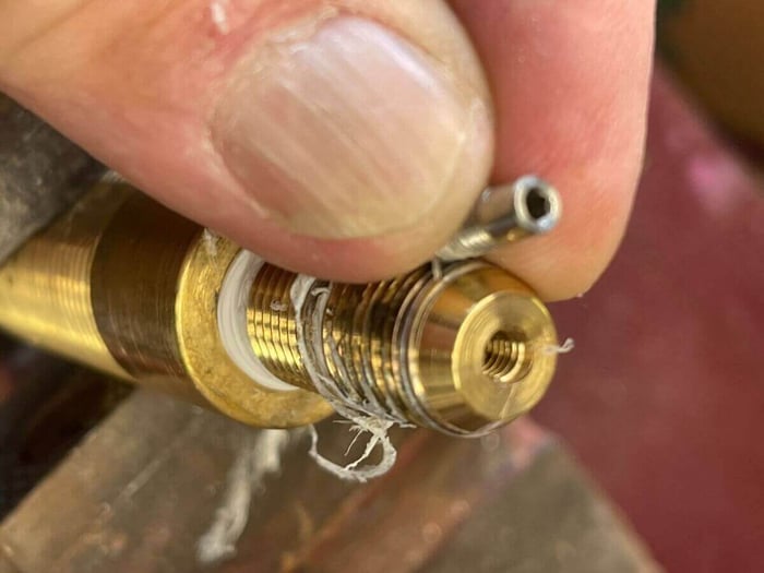 Jet removed from the brass fitting and ready for clearing