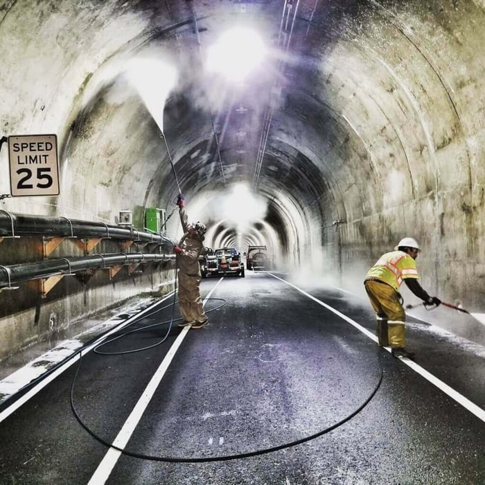 Carlos Gonzalez walking through an industrial tunnel at a commercial cleaning job