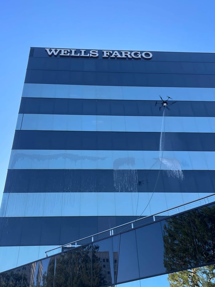 drone cleaning windows on building