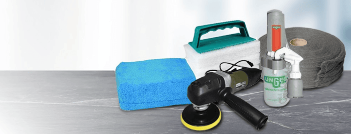 Scrubbers and polishing pads laid out for professional window and glass cleaning