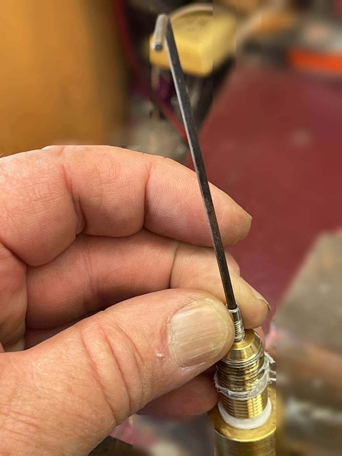 Allen key wrench removing the nozzle tip from the brass inlet body
