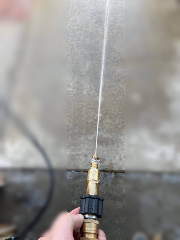 Water spraying from the cleared nozzle assembly during test