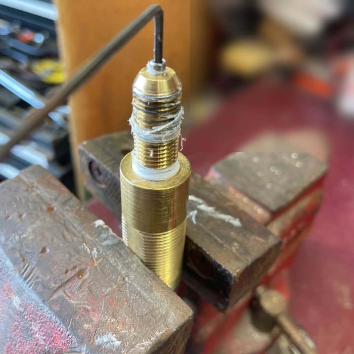 Nozzle tip being hand-threaded back into the water inlet body