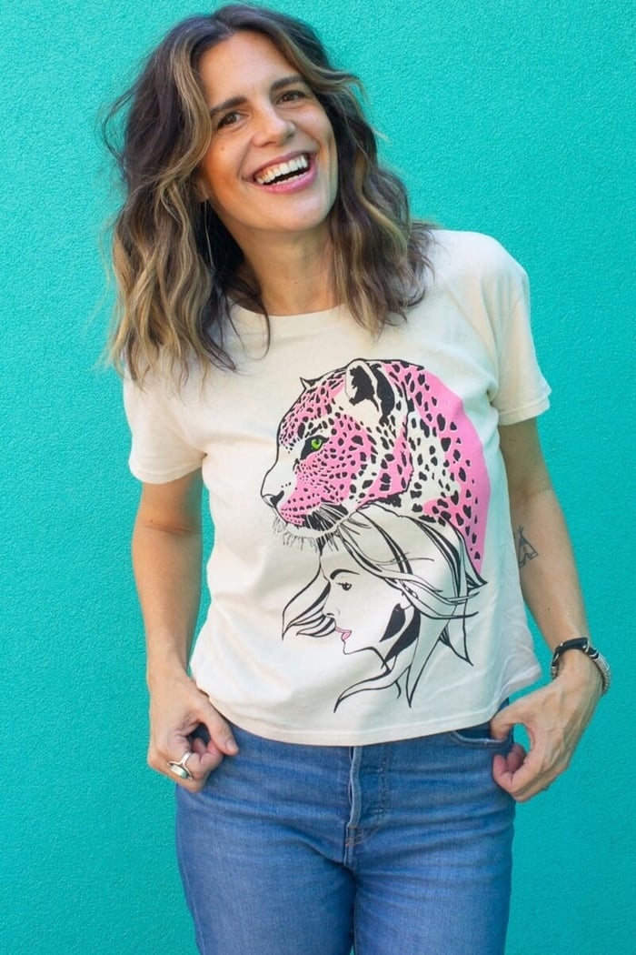 Angela wearing the Thread Hippie Wild Within women’s graphic tee styled with classic blue Levi’s jeans.