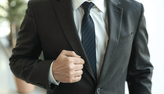 A stylish man showing an exception to the suit buttoning rules.