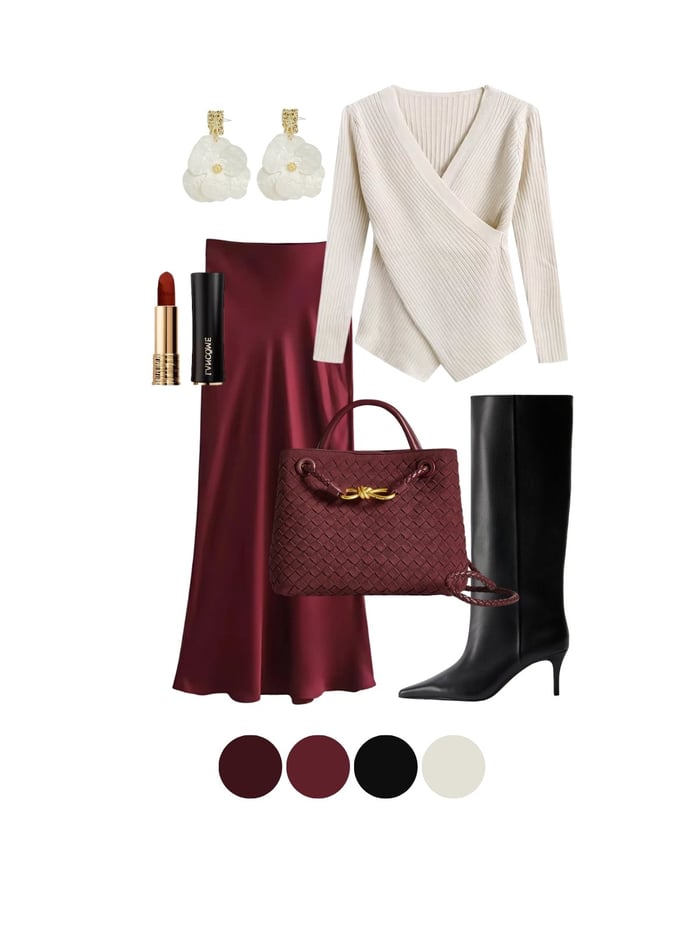 Burgundy outfits 2025 – satin skirt with ivory wrap top, black boots, woven bag, and statement earrings.