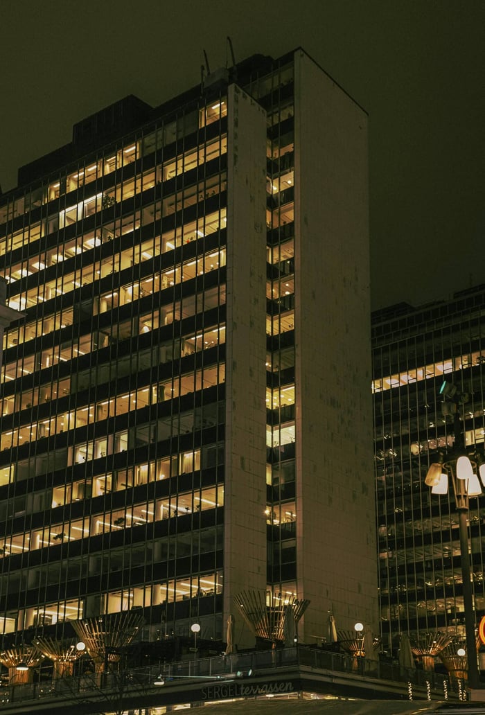 Illuminated office buildings in Stockholm during the night, showcasing urban architecture.