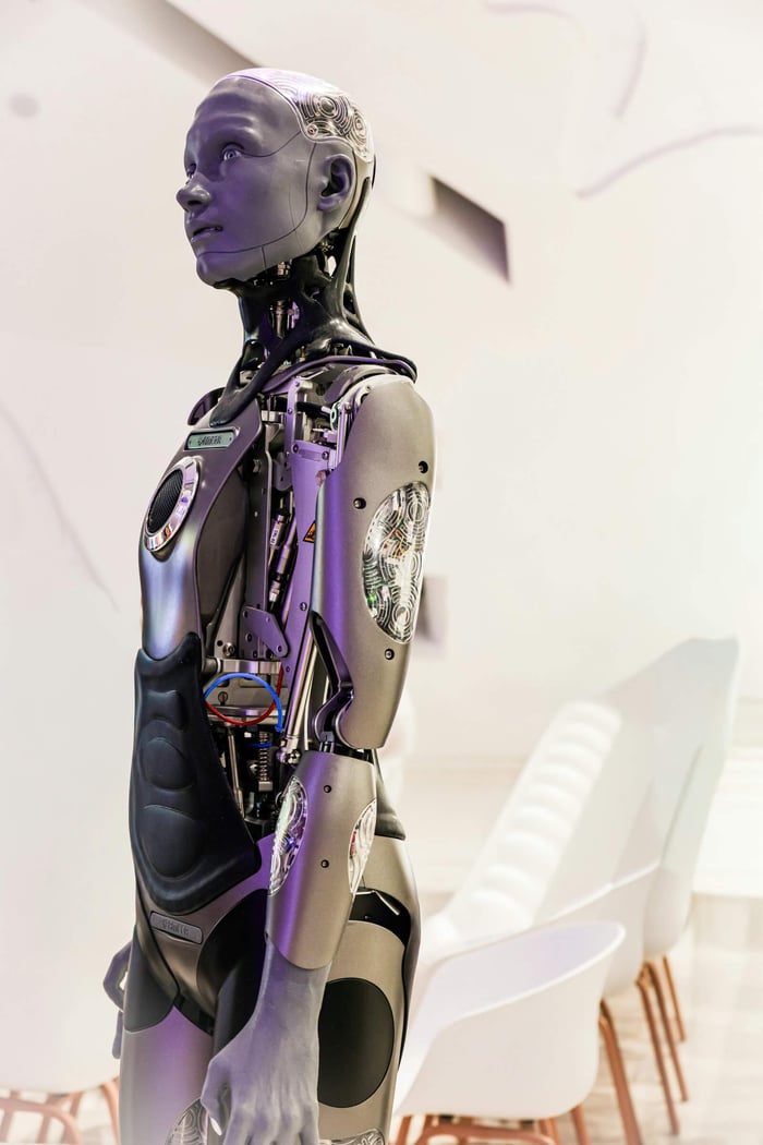 Sleek humanoid robot displayed in a contemporary conference setting, showcasing advanced technology.
