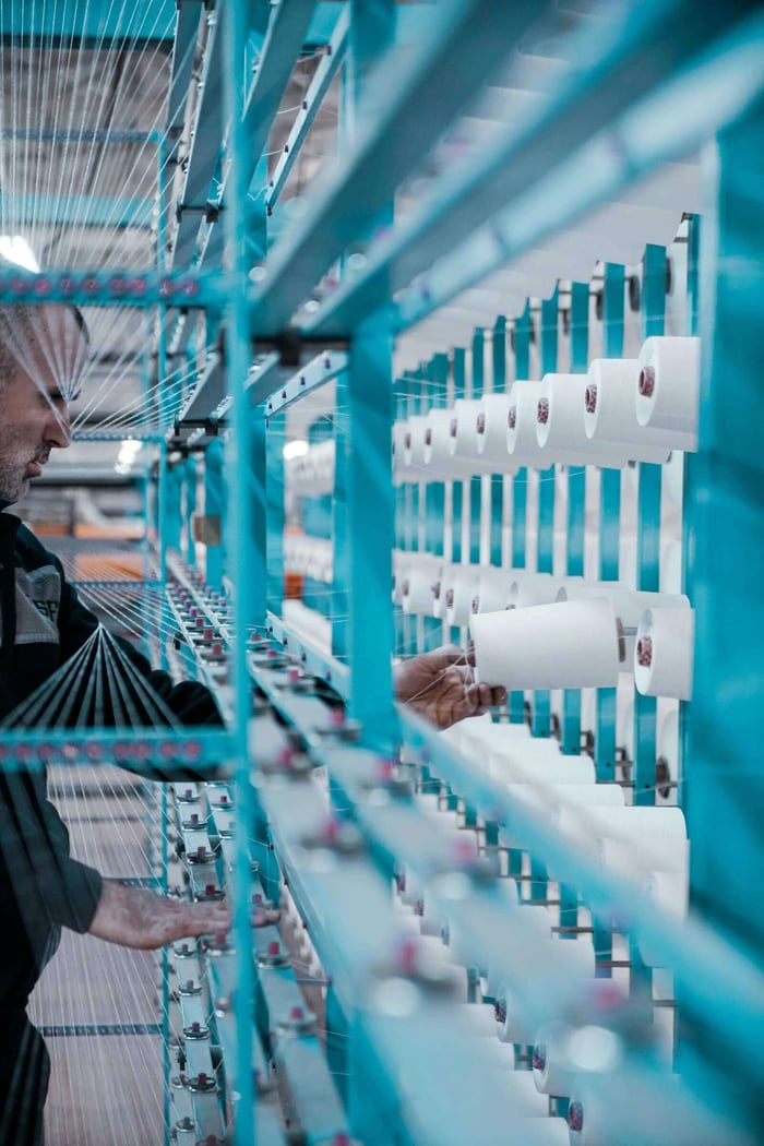 manufacturing sales manager reviewing a comparison table of lead generation services