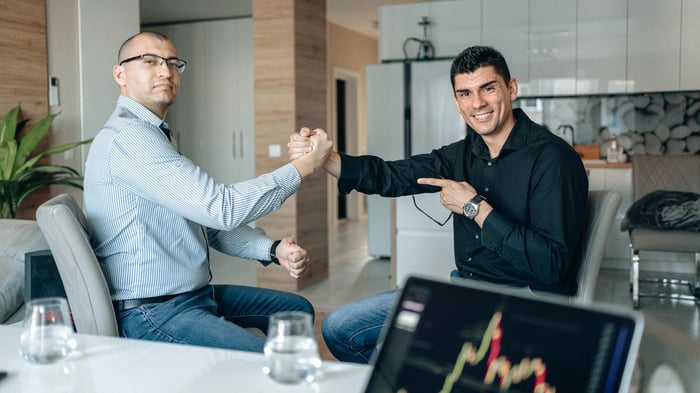 investment banking team analyzing market intelligence and deal trigger signals on a large screen