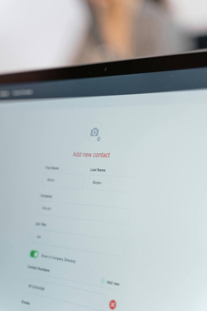Close-up of a computer screen with an open contact form for adding a new entry.