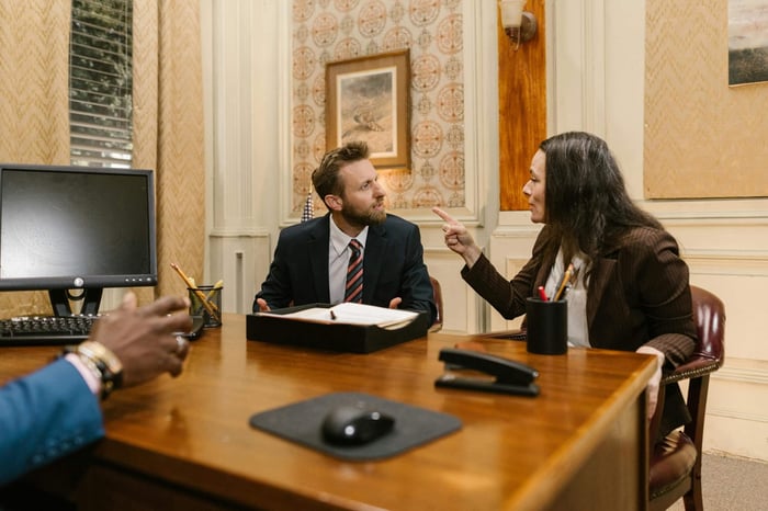 investment banking team collaborating on a CRM system showing a complex M&A deal pipeline