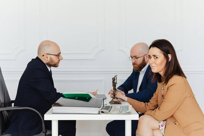 compliance officer analyzing regulatory documents with AI assistance for lead generation targeting