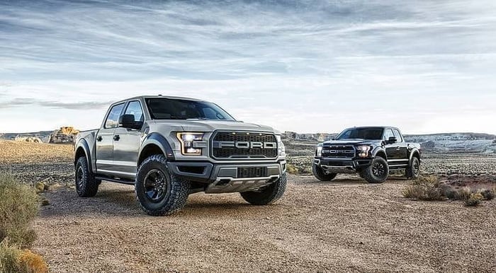 Two Ford F 150 vehicles in the desert that provide added comforts for the driver and tools to make it more powerful.