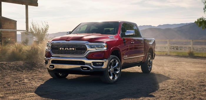 Red Ram Truck with crew cab, ample cargo capacity, and infotainment system parked in Texas Hill country.