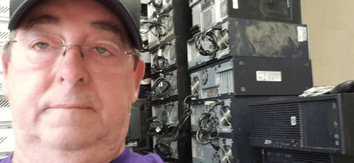 Reselling tips - Man reselling computer hard drive stacks.