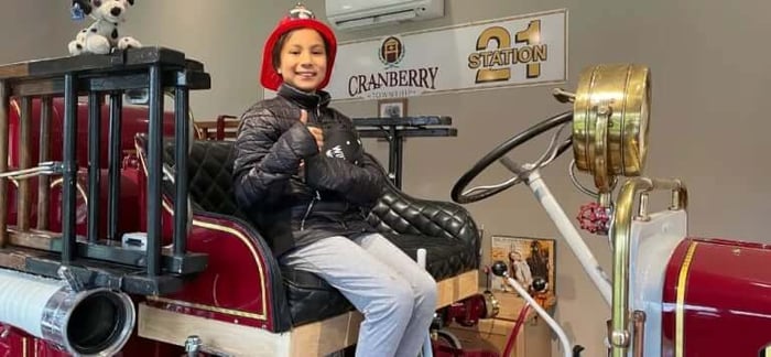 Tatiana got to sit in a 100 year old fire truck, unlike her dad.