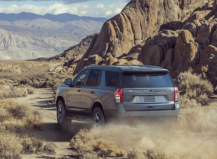 Dark grey Chevy Tahoe three row SUV with ample cargo space, all terrain tires, V8 engine, four wheel drive and super cruise control.
