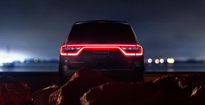 Dodge Durango parked at night with lights in the distance.