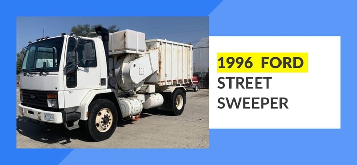 Parked white 1996 Ford Street Sweeper.