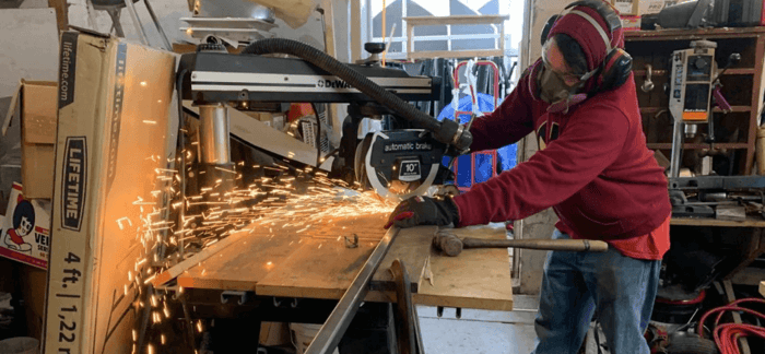 Reselling tips -Woman using metal tools to construct furniture.