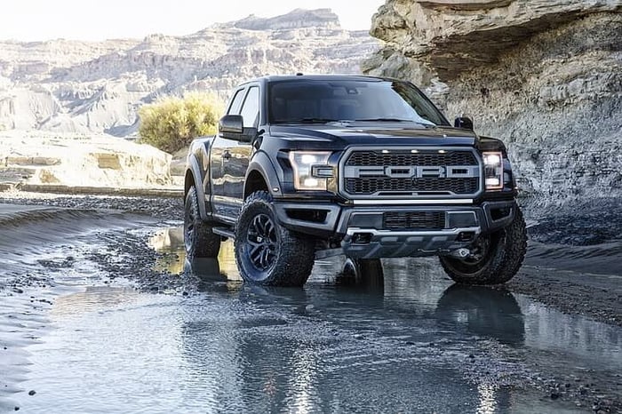 Black Ford F 150, demonstrating the difference between it and the competitors, with regular cab truck bed measuring 96 inches long.
